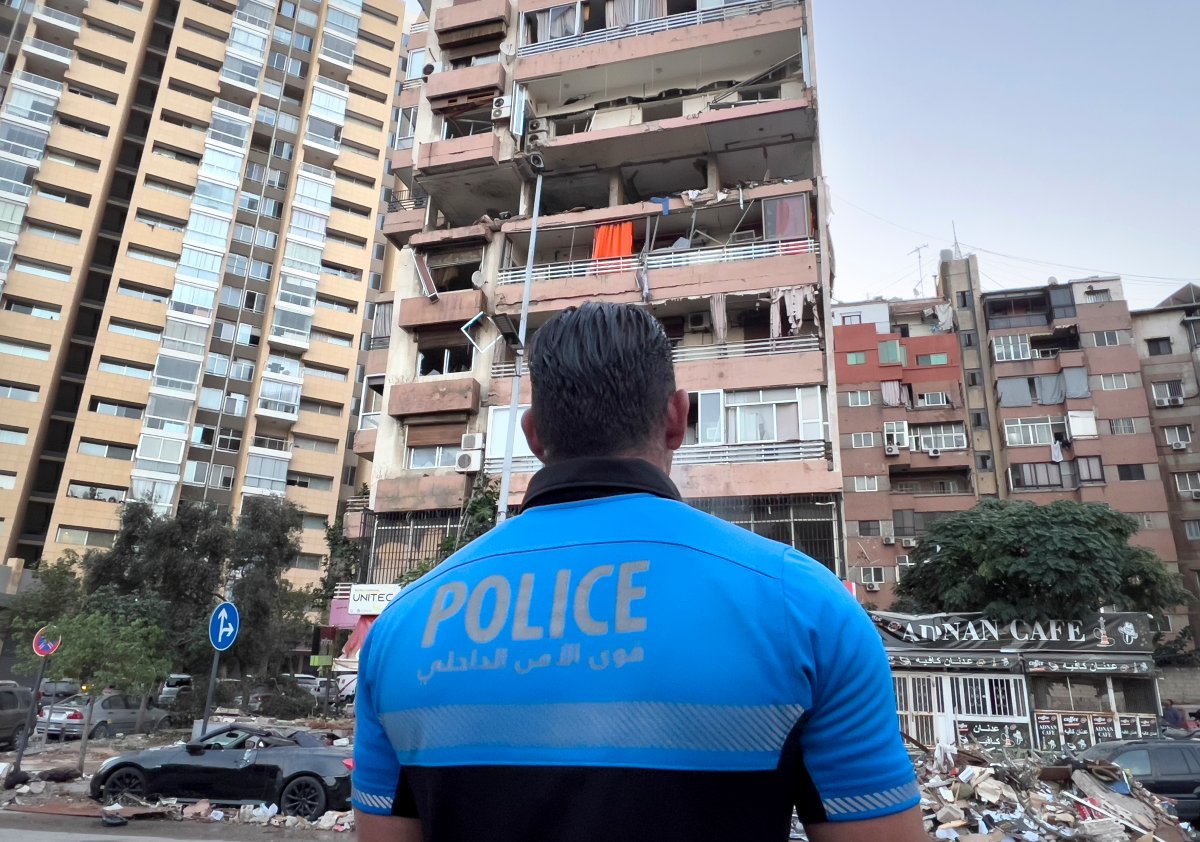 A Lebanese policeman looks at damaged apartments that were hit by Israeli strike early Monday, Sept. 30, 2024, in Beirut, Lebanon. (AP Photo/Hussein Malla)