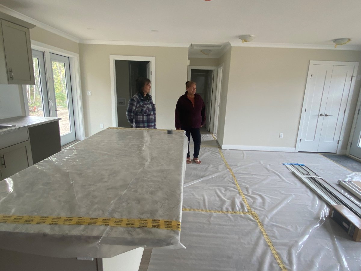 Grace and Darlene Richards touring a new home similar to the ones they will move into in Conklin, thanks to donations by oil and gas company Cenovus.