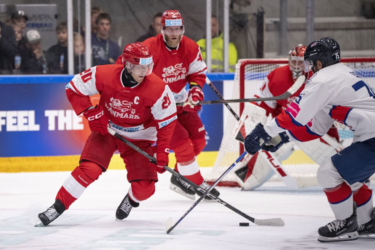 Denmark's Lars Ellers, left, faces England's Robert Dowd during the ice hockey Olympic qualification match between Denmark and Great Britain in Aalborg, Denmark, Thursday, Aug. 29, 2024.