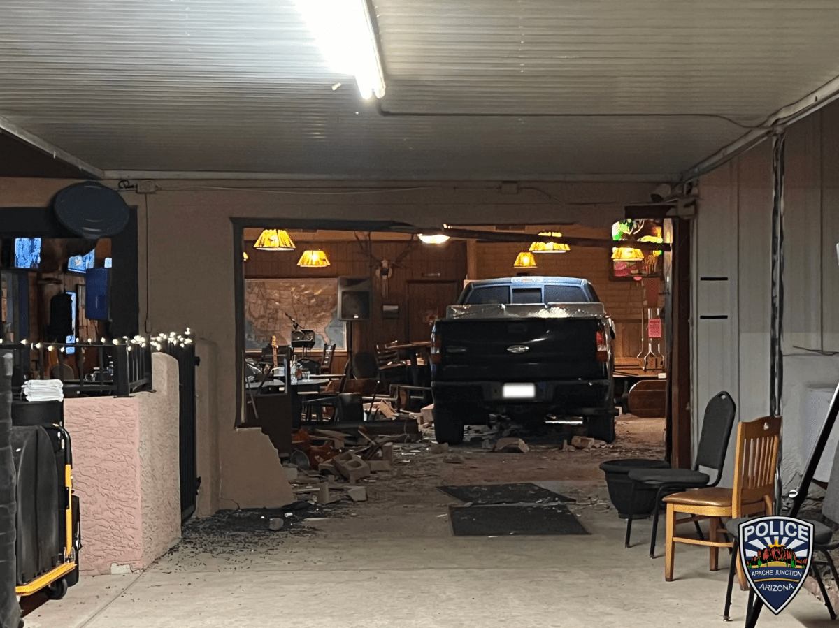 A black Ford F-150 sits in the middle of an Elks Lodge in Arizona, shortly after a man drove the vehicle through the side of the building.