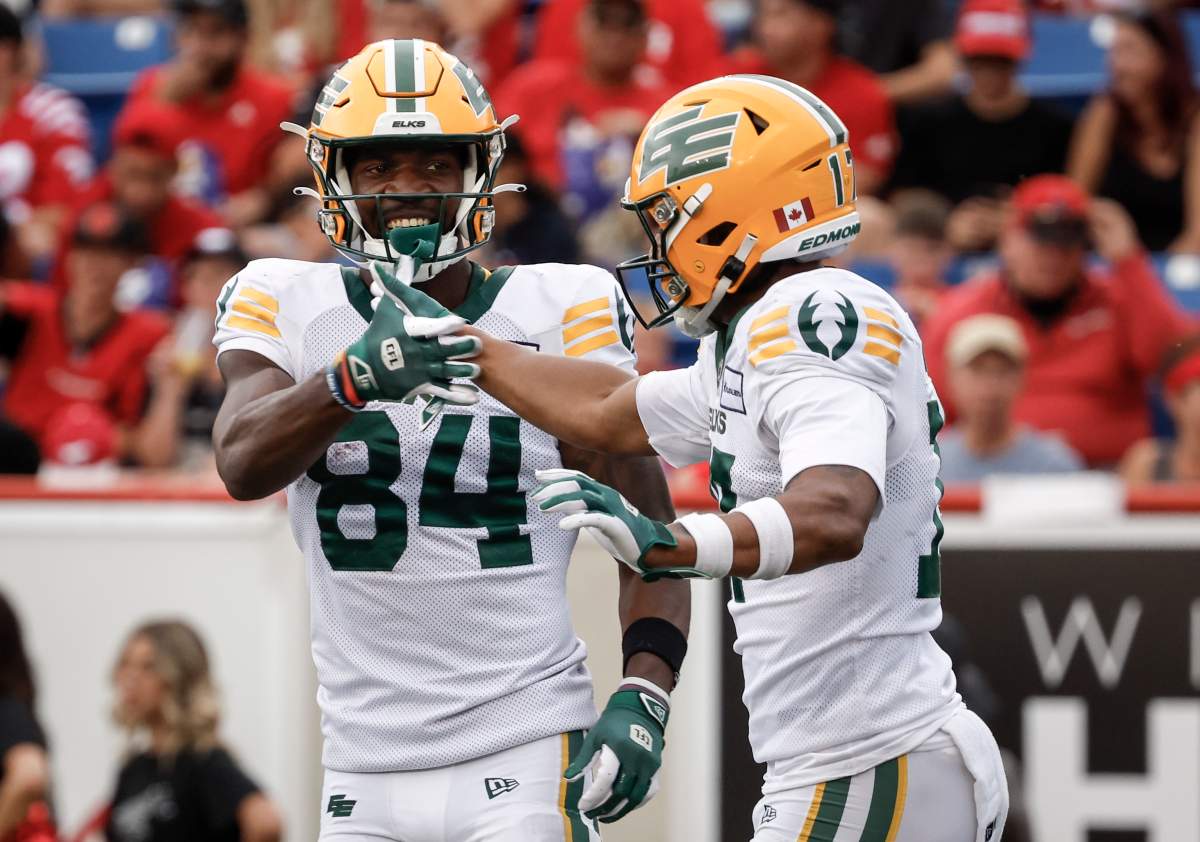 Edmonton Elks' Tevin Jones (84) celebrates his touchdown with Dillon Mitchell (17) during second half CFL football action in Calgary, Monday, Sept. 2, 2024.
