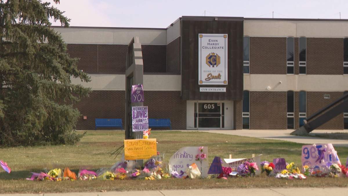 Flowers and signs of support have been left outside Evan Hardy Collegiate after a 15-year-old girl was lit on fire at school on Sept. 5, 2024.