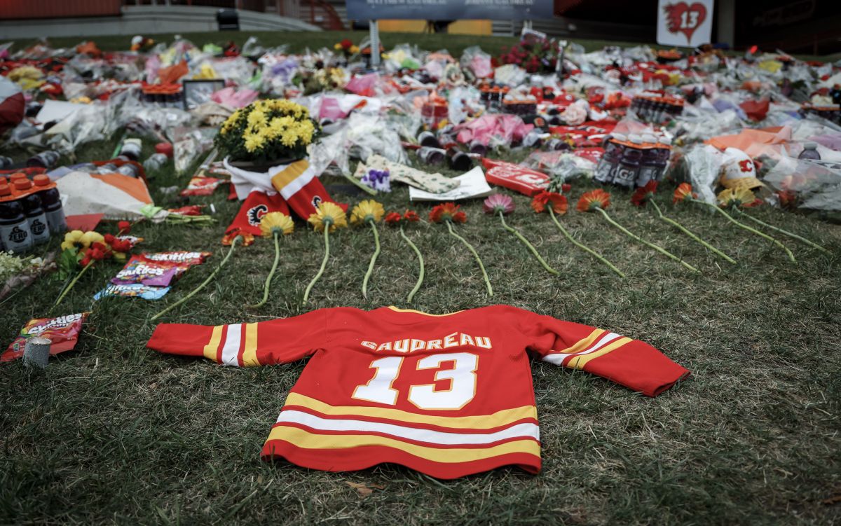 Flowers and memorabilia for former Calgary Flames player Johnny Gaudreau and his brother Matthew lie on the grass outside the Saddledome in Calgary, Alta., Wednesday, Sept. 4, 2024. The brothers were struck and killed by a suspected drunk driver last week while cycling near their childhood home in New Jersey.