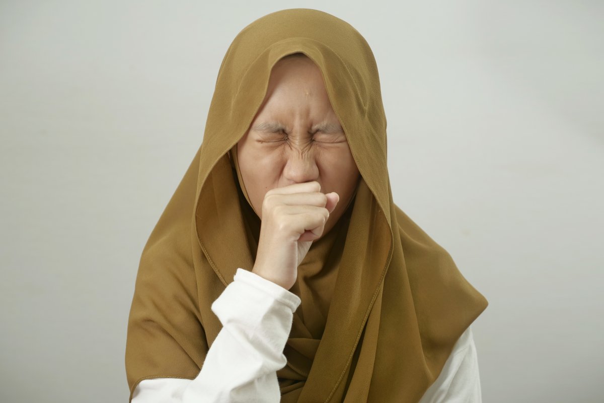 Asian muslim teenage girl wearing hijab cough, respiratory health problem, medical disease health care concept