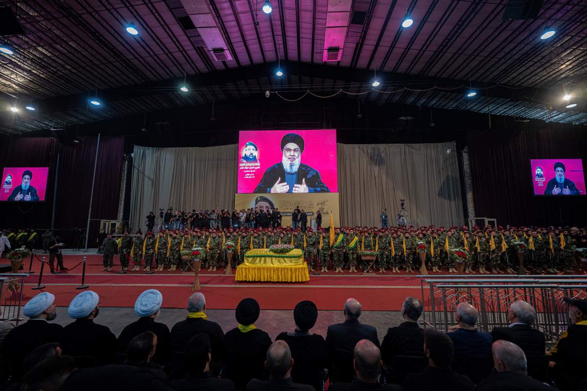 A televised speech by Hezbollah chief Hassan Nasrallah is transmitted on large screens as fighters and mourners attend the funeral ceremony of slain top commander Fuad Shukr in Beirut’s southern suburbs on August 1, 2024. Hezbollah on August 1 mourned Shukr, whose body was recovered from the rubble of a July 30 Israeli strike in south Beirut that also killed five civilians, three women and two children, and injured dozens, according to Lebanon’s health ministry, as fears mounted of a wider conflict in the region.