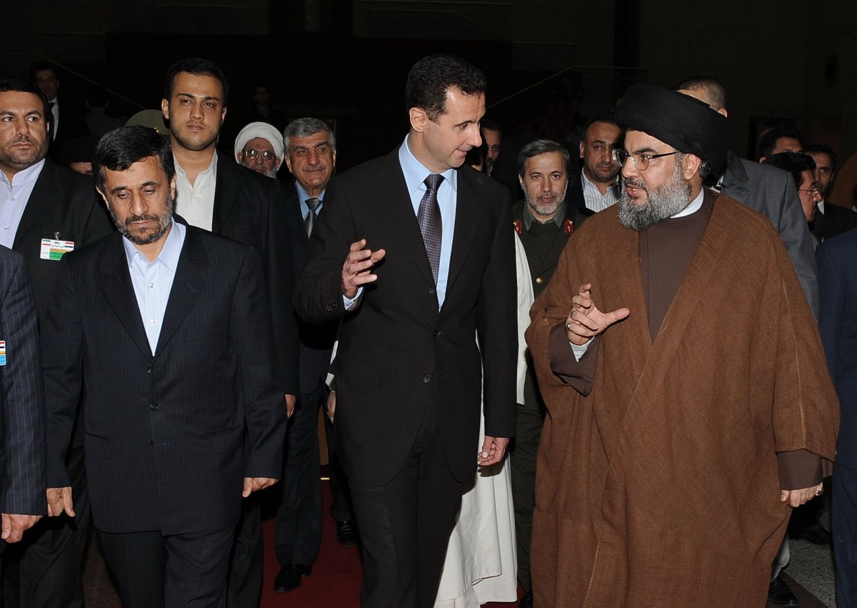 Syrian President Bashar al-Assad (C) holds a reception in honour of the Iranian President Mahmoud Ahmadinejad (L) with the presence of Hezbollah chief Hassan Nasrallah (R) on February 25, 2010 in Damascus, Syria.