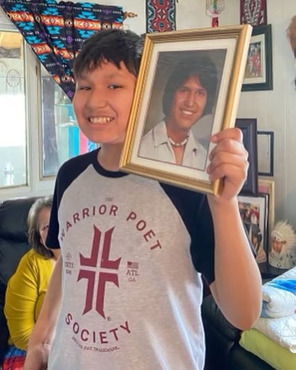 An undated photo of Hoss Lightning holding a photo of his late grandfather Hoss Saddleback, after whom he was named.