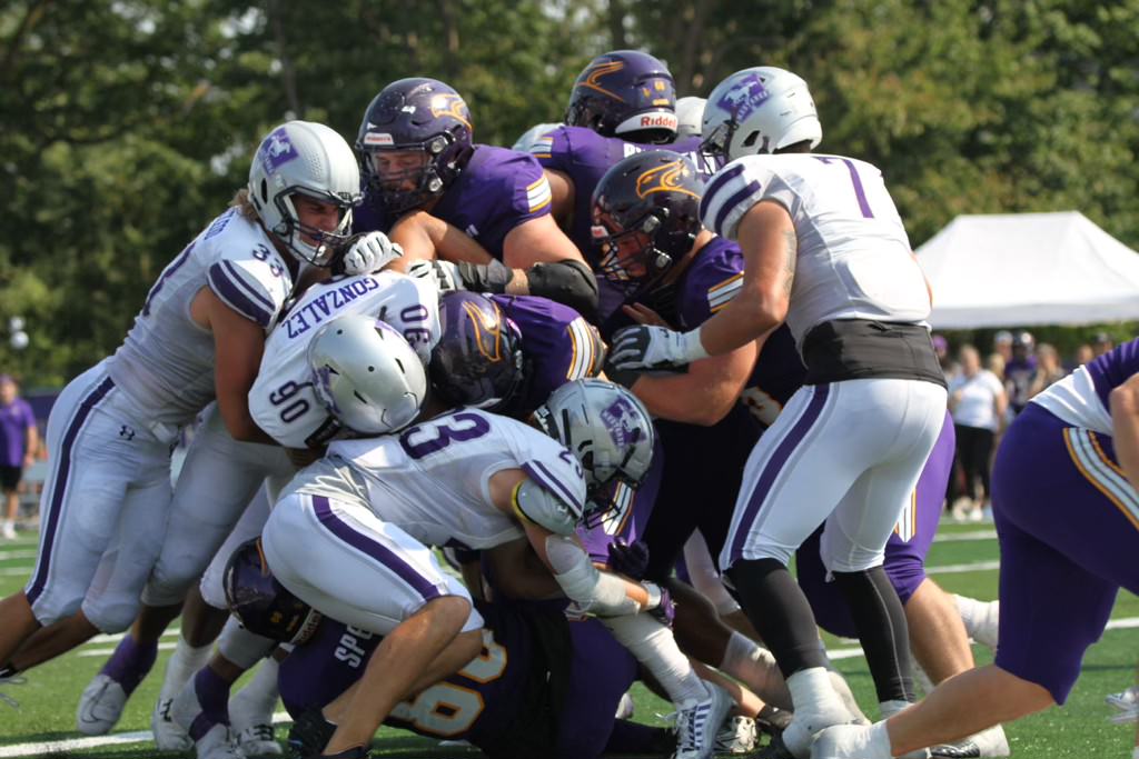 Western's defence led by Nate Gonzalez (90), Riley MacLeod (33) and Ryan Barthelson (23), attempts to stop the Laurier Golden Hawks offence in a game played in Waterloo, Ont., on Sept. 14, 2024.