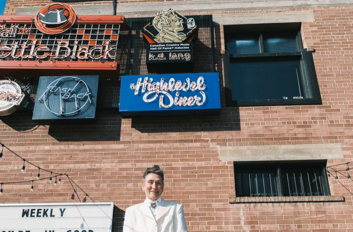 k.d. lang poses in front of a sign put up in her honour at Edmonton's Neon Sign Museum in this undated photo.