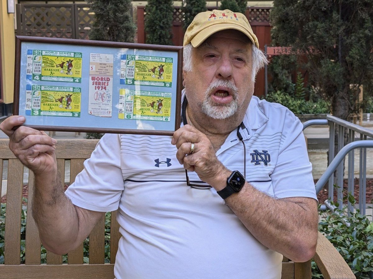 Longtime Oakland A's fan Mike Silva holds up his framed ticket stubs from the team's World Series games at the Oakland Coliseum, July 16, 2024, in San Jose, Calif., from 1972-74, resulting in three of the nine World Series titles dating back to the franchise's origins in Philadelphia.