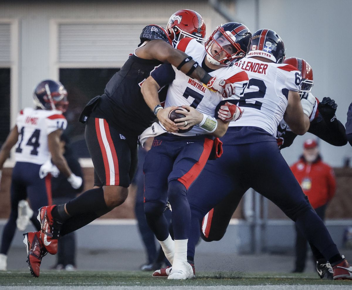 Montreal Alouettes quarterback Cody Fajardo (7) is sacked by Calgary Stampeders' Elliot Graham (37) during second half CFL football action in Calgary, Saturday, Sept. 14, 2024.