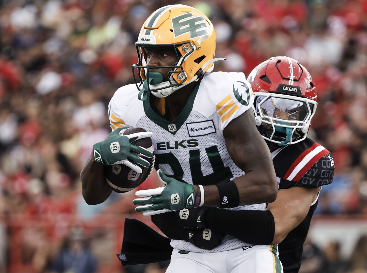 Edmonton Elks' Tevin Jones (84) is tackled by Calgary Stampeders' Branden Dozier (3) during first half CFL football action in Calgary, Monday, Sept. 2, 2024.