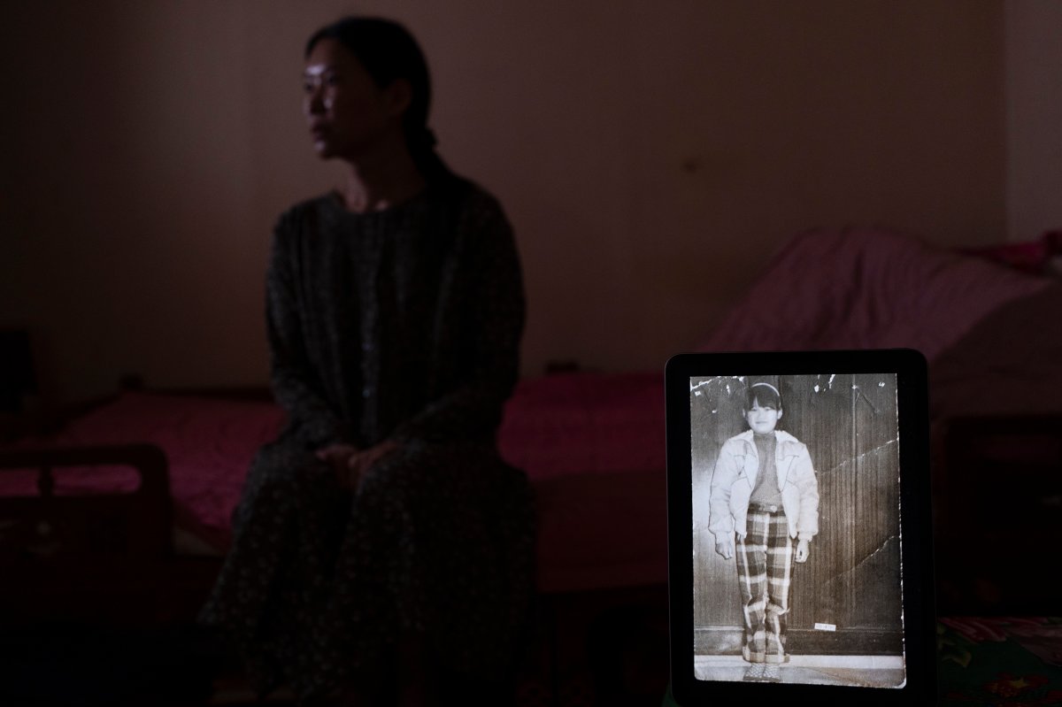 Yooree Kim sits for a portrait with a computer tablet displaying a picture of her taken before she was sent from South Korea to be adopted by a family in France when she was 11 years old, in her apartment in Seoul, South Korea, Sunday, May 19, 2024. 