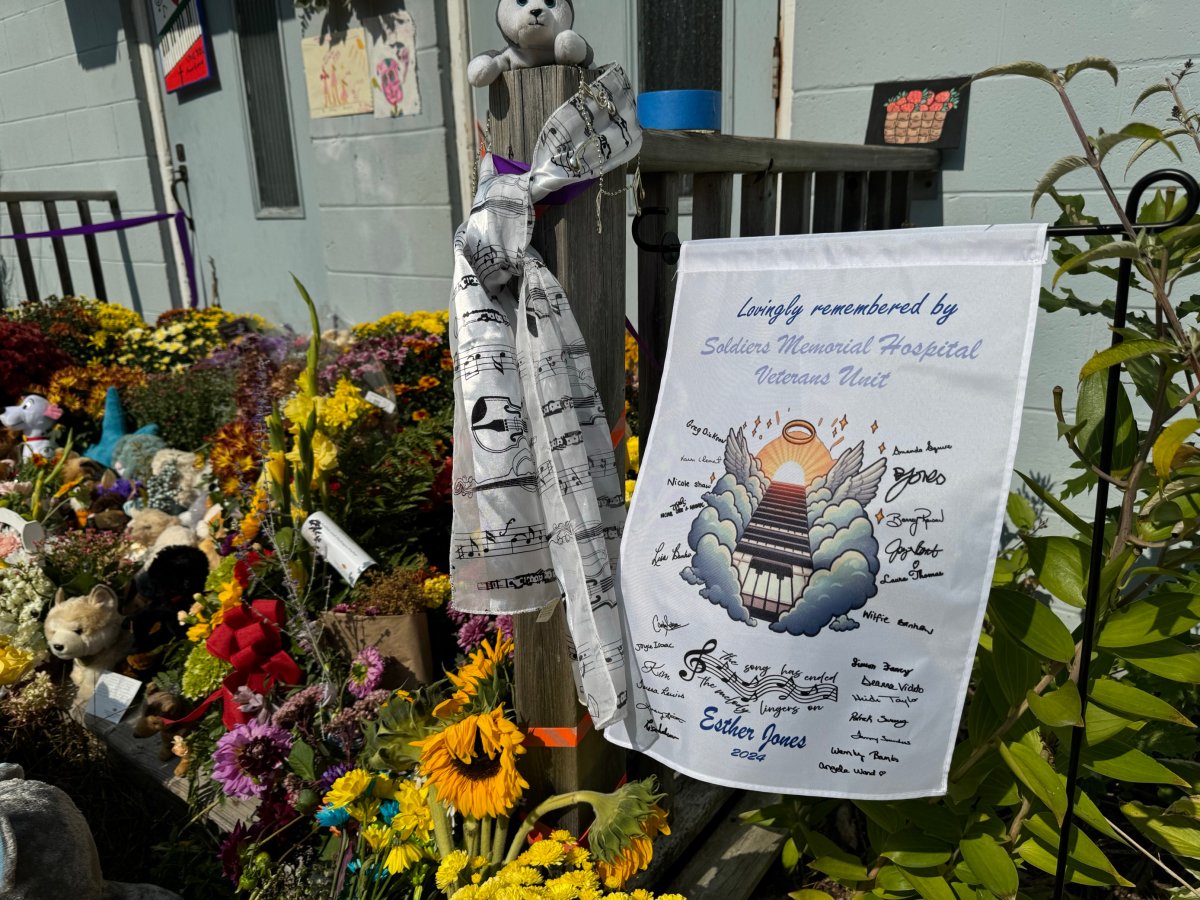 Flower and tributes are shown outside the Kingston Bible College in Greenwood, N.S. where Esther Jones was last seen. RCMP have charged Dale Allen Toole, 54, with first-degree murder in connection to her death.