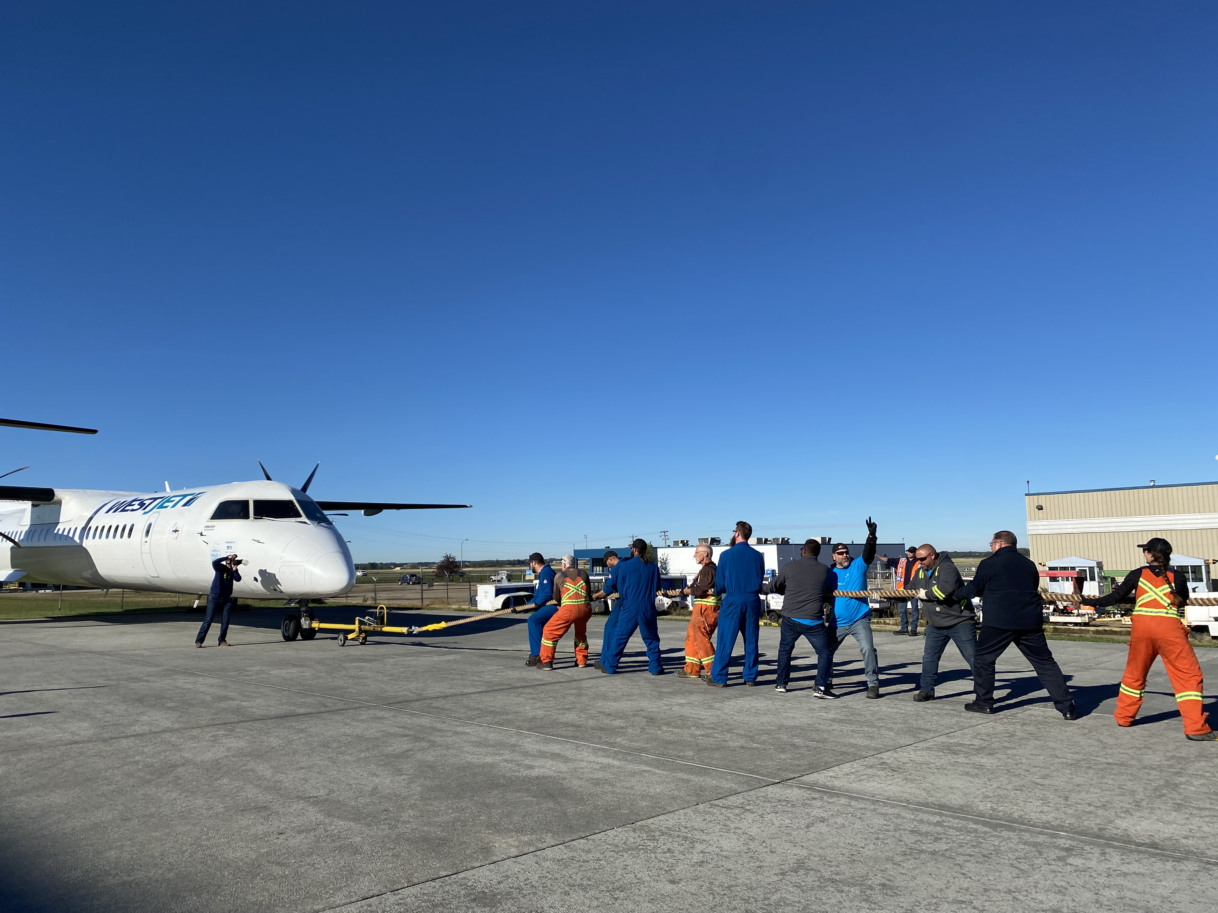 Plane pull at Edmonton airport raises money, awareness for Hope Air