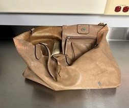 The unknown woman had this bag in her possession when her body was found, police say.
