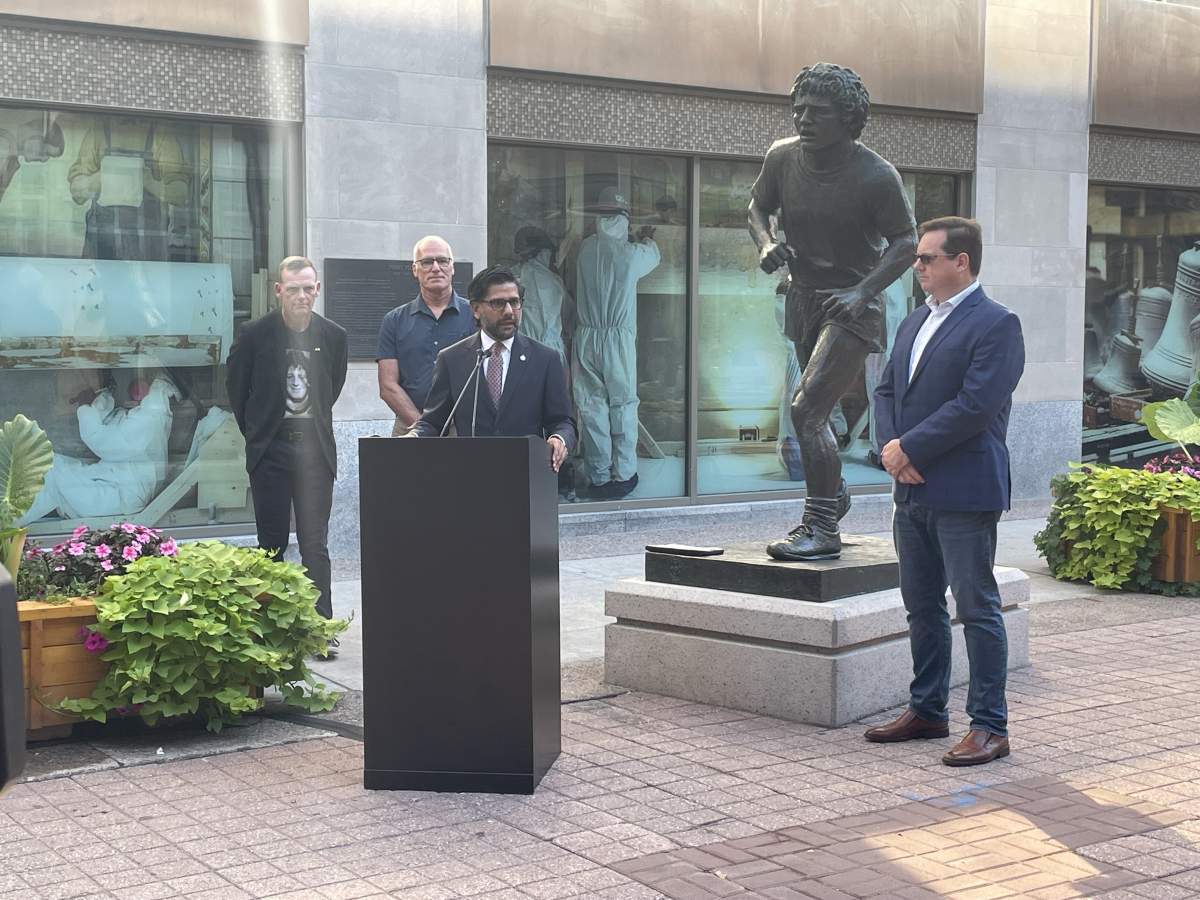 Liberal MP Yasir Naqvi formally announces the relocation of the Terry Fox Memorial Statue to Sparks Street in Ottawa on Sept. 16, 2024. He was joined by Fox’s brother Darrell, far left, sculptor John Hooper’s son – also named John Hooper, and Kevin McHale, executive director of the Sparks Street Business Improvement Area.