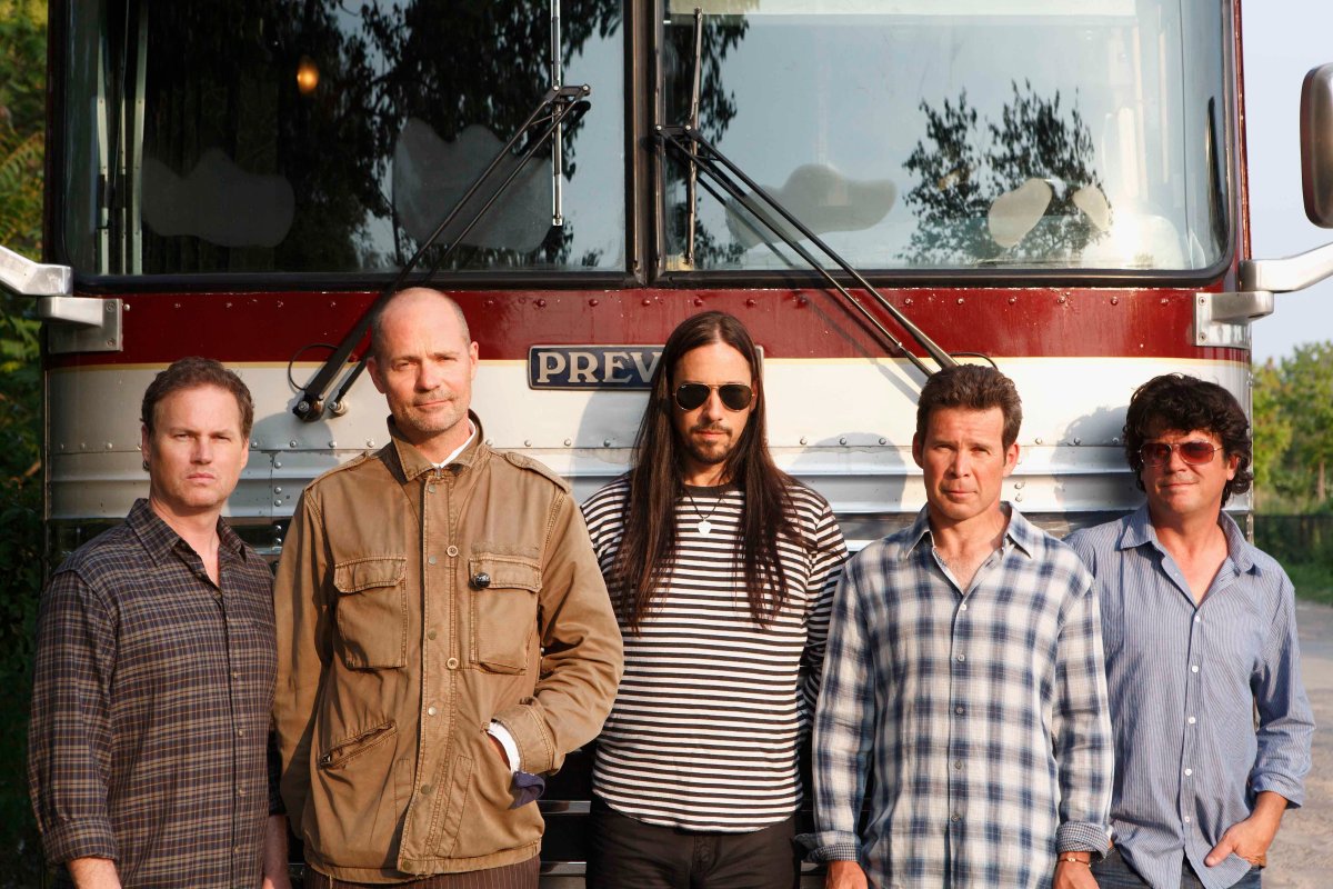 The Tragically Hip, from L-R: Johnny Fay, Gord Downie, Rob Baker, Gord Sinclair, Paul Langlois, pictured in front of a tour bus.