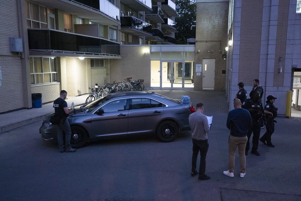 Toronto Police work the scene where a police officer was shot in Toronto, on Wednesday, Oct. 2, 2024. The officer was rushed to hospital.