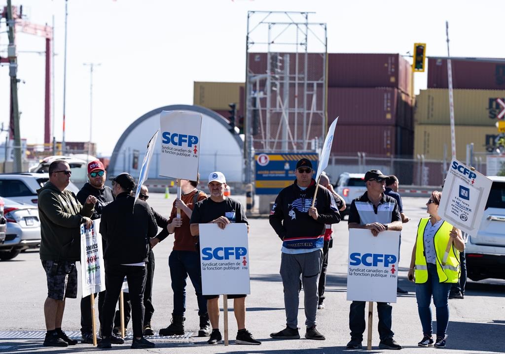 Port of Montreal longshore workers begin a three-day strike outside the Viau terminal in Montreal, Monday, Sept. 30, 2024. Dockworkers at the Port of Montreal are set to halt all overtime work this morning in a pressure tactic targetting their employers as contract talks continue. THE CANADIAN PRESS/Christinne Muschi.