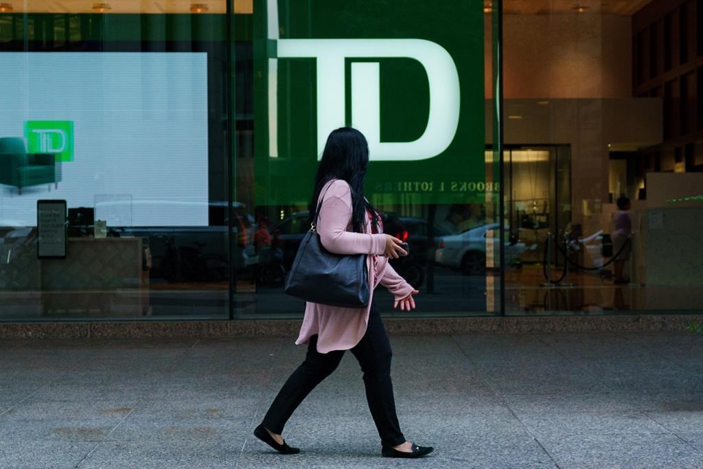 A person walks past a TD Bank sign in the financial district in Toronto on Tuesday, Sept. 20, 2022.