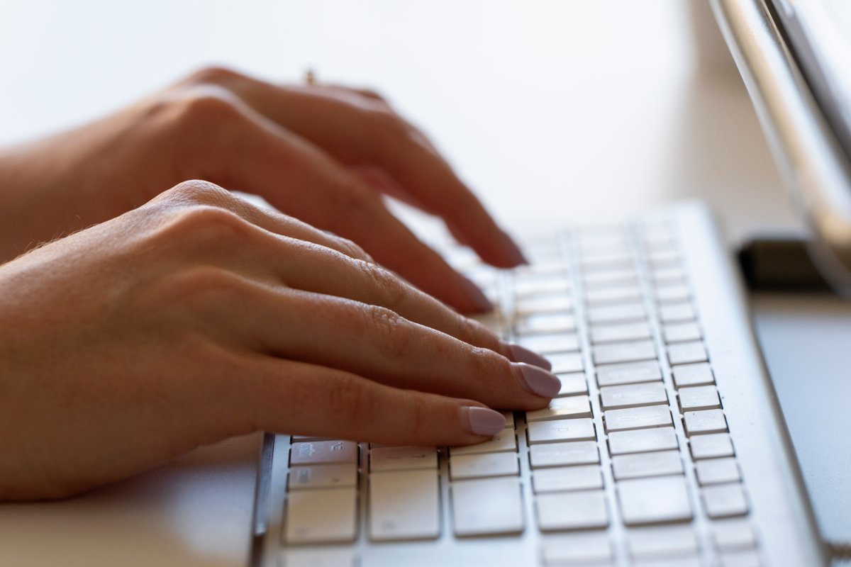 A person types on a keyboard.