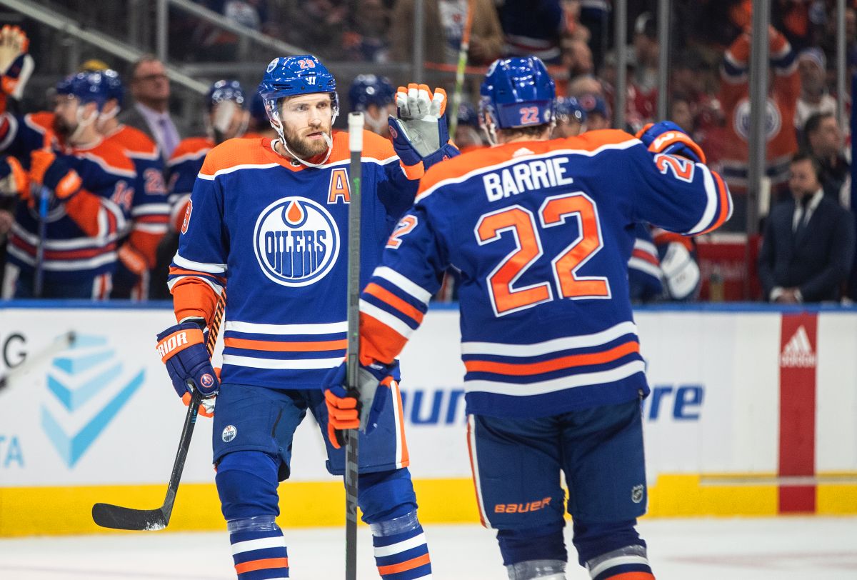 Edmonton Oilers' Leon Draisaitl (29) and Tyson Barrie (22) celebrate a goal against the Montreal Canadiens during second period NHL action in Edmonton on Saturday, December 3, 2022.