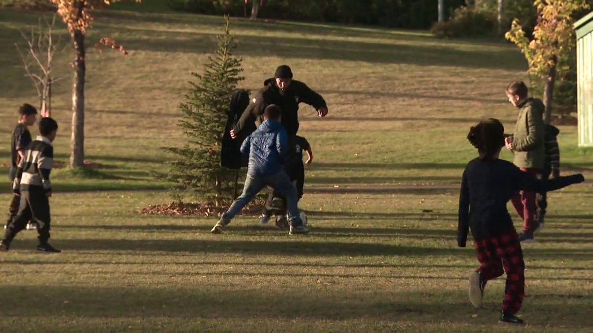 Boris Bede plays soccer with a group of kids in northeast Edmonton in 2024.