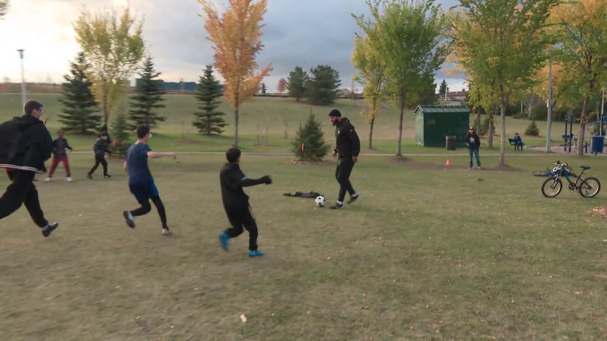 Boris Bede plays soccer with a group of kids in northeast Edmonton in 2024.