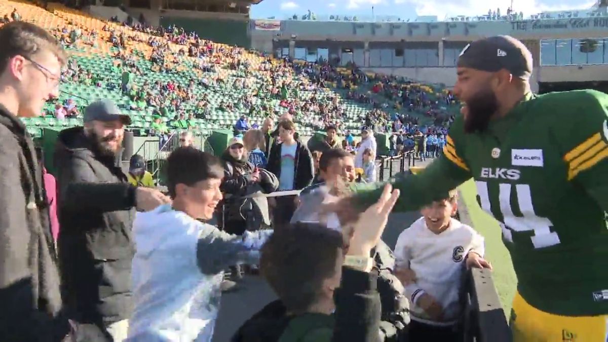 Boris Bede greets some of the kids that he plays soccer with at an Edmonton Elks game in 2024.