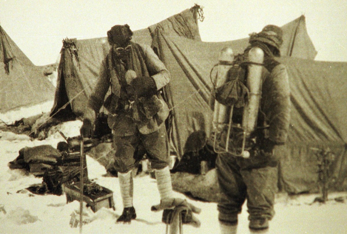 Andrew Irvine and George Mallory in an old photo, wearing climbing gear.