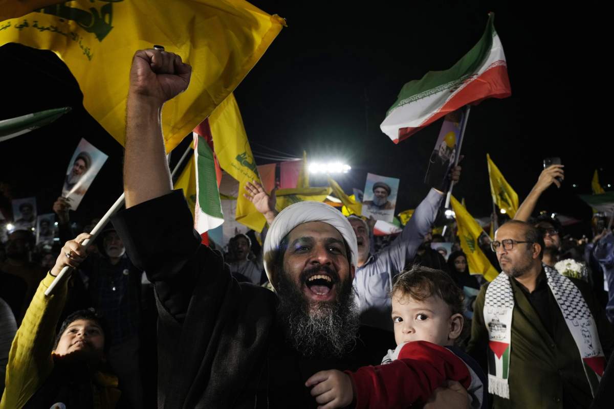 A cleric clenches his fist as he celebrates Iran’s missile strike against Israel in an anti-Israeli gathering at Felestin (Palestine) Sq. in Tehran, Iran, Tuesday, Oct. 1, 2024. (AP Photo/Vahid Salemi)