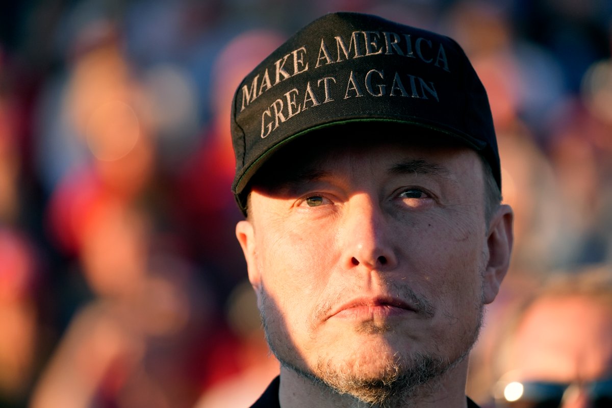 Tesla and SpaceX CEO Elon Musk listens as Republican presidential nominee former President Donald Trump speaks at a campaign event at the Butler Farm Show, Saturday, Oct. 5, 2024, in Butler, Pa. (AP Photo/Alex Brandon)