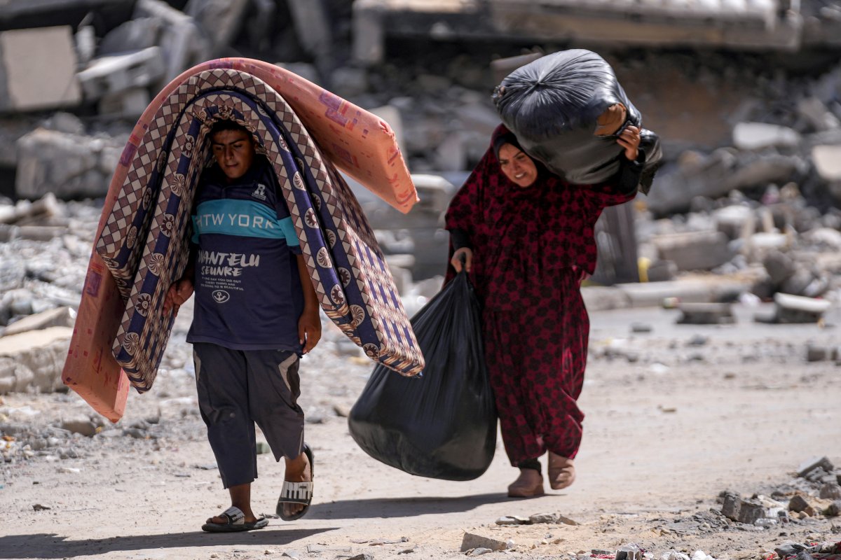 FILE - Palestinians displaced by the Israeli air and ground offensive on the Gaza Strip flee from Hamad City, following an evacuation order by the Israeli army to leave parts of the southern area of Khan Younis, Sunday, Aug. 11, 2024.