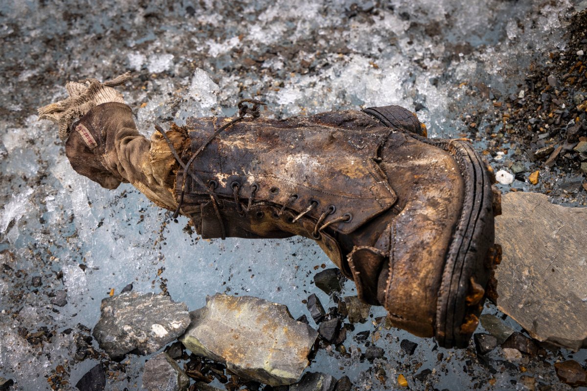 An old boot and sock in the ice.