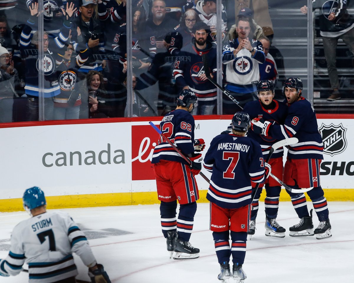 Winnipeg Jets' Nino Niederreiter (62), Vladislav Namestnikov (7), Cole Perfetti (91) and Alex Iafallo (9) celebrate Perfetti's goal against the San Jose Sharks during third period NHL action in Winnipeg on Friday, October 18, 2024. THE CANADIAN PRESS/John Woods.