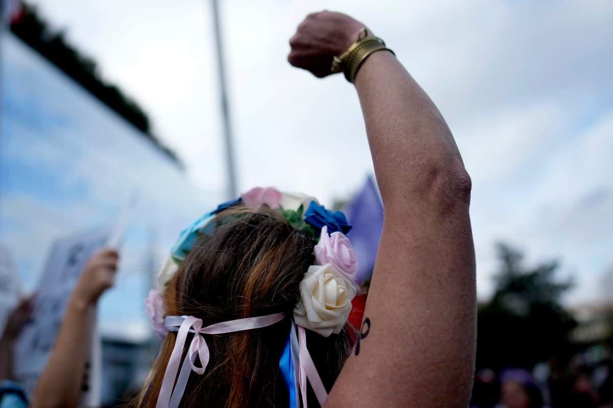 People gather to take part in a protest against sexual violence, in Paris, France, Saturday, Oct. 19, 2024.