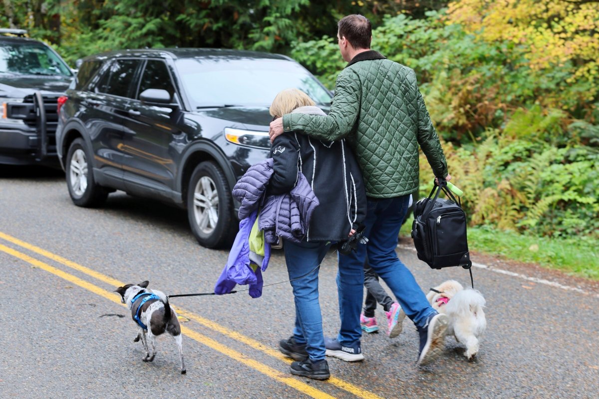 Neighbours leave the scene of a fatal shooting Monday morning, Oct. 21, 2024, in Fall City, Wash.