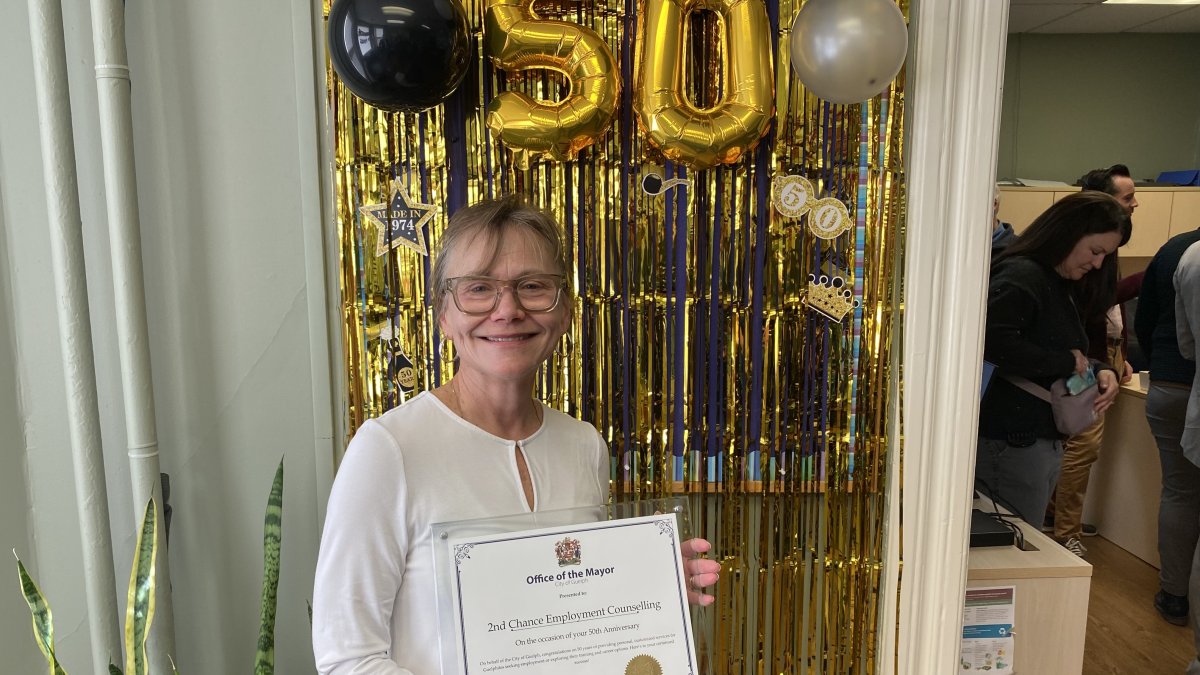 2nd Chance Employment Counselling executive director Chris Baginski-Hansen holds a certificate from the City of Guelph to mark 50 years of the agency's existence.