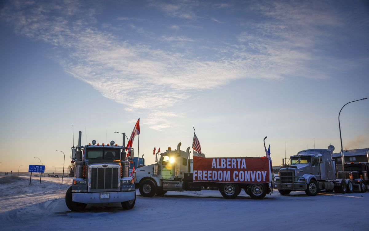 A truck convoy of anti-COVID-19 vaccine mandate demonstrators block the highway at the busy U.S. border crossing in Coutts, Alta., Wednesday, Feb. 2, 2022.