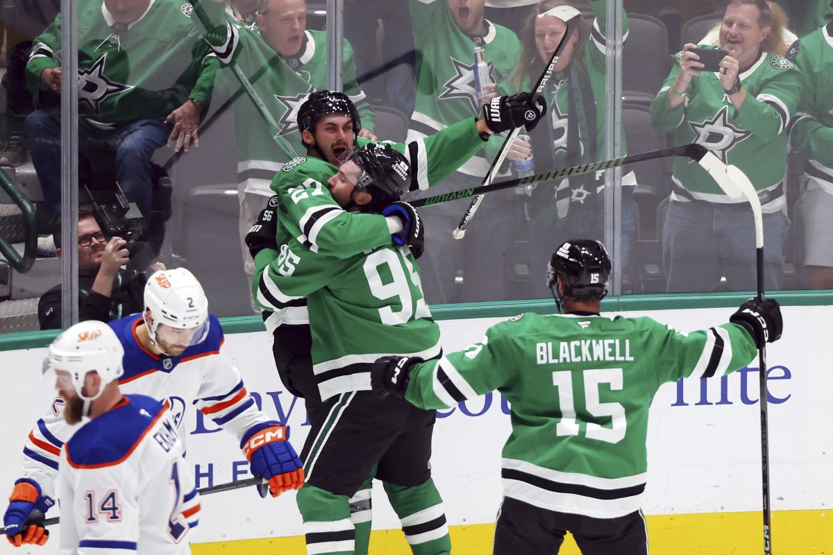 Dallas Stars left wing Mason Marchment (27) is hugged by Stars centre Matt Duchene (95) after a goal against the Edmonton Oilers in the third period during an NHL hockey game on Saturday, Oct. 19, 2024, in Dallas.