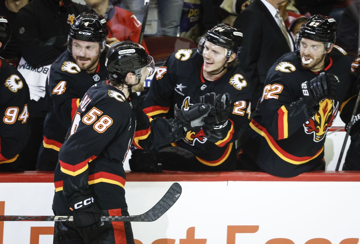 Calgary Flames' Justin Kirkland (58) celebrates his goal with teammates during shootout NHL hockey action against the Pittsburgh Penguins in Calgary on Tuesday, Oct. 22, 2024.