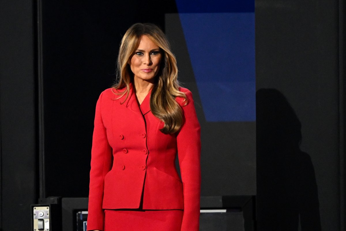 Melania Trump in a red blazer and skirt.