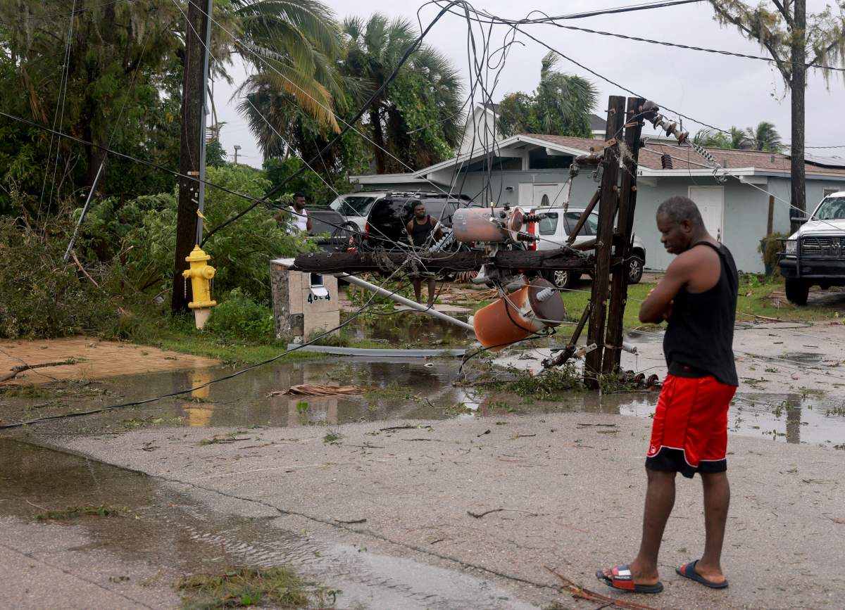 FORT MYERS, FLORIDA - OCTOBER 09: A power pole lays on the ground after it was snapped in half after what appeared to be a tornado passed through the area before Hurricane Milton's arrival on October 09, 2024, in Fort Myers, Florida. People are preparing for the storm, which could be a Cat 3 when it makes landfall on Wednesday evening.