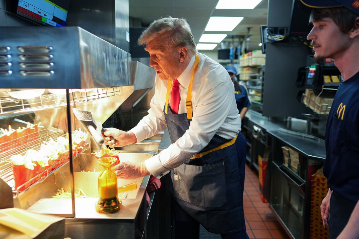 Donald Trump serving french fries in an apron.