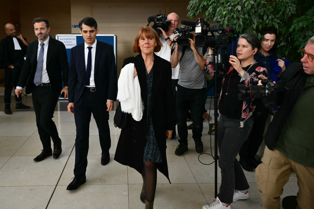 Gisèle Pélicot (C) flanked by her lawyers Antoine Camus (L) and Stephane Babonneau (2ndL), leaves the court at the Avignon courthouse after attending the trial of her former partner Dominique Pélicot accused of drugging her for nearly 10 years and inviting strangers to rape her at their home in Mazan, a small town in the south of France, in Avignon, on Oct. 23, 2024.