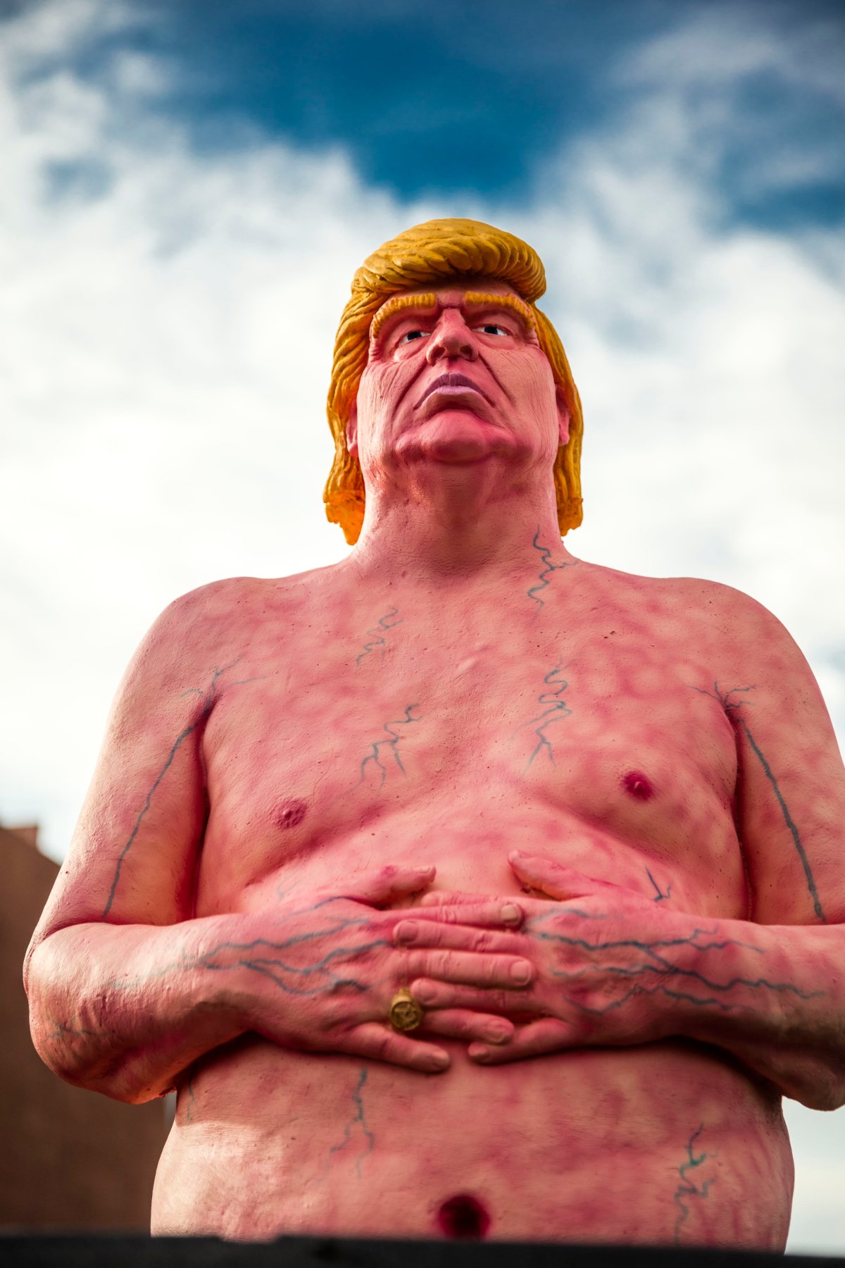 A statue of Trump naked. The sculpture is pink with visible veins.