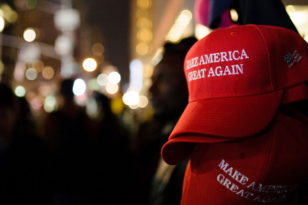 FILE - "Make America Great Again" red baseball caps, signature headwear of the Donald Trump campaign and its supporters, stand on sale in New York City.