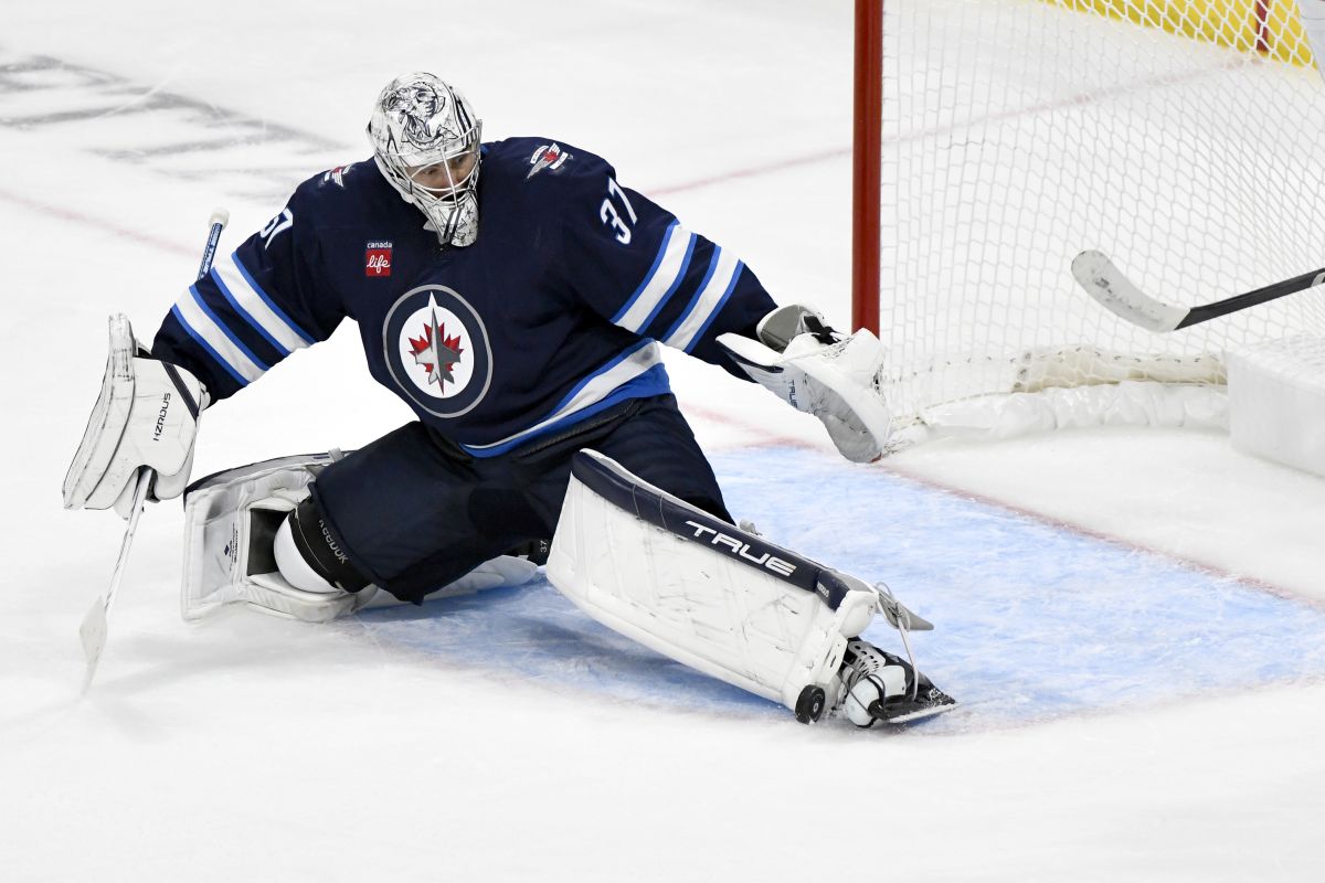 Winnipeg Jets goalie Connor Hellebuyck (37) makes a save on a Minnesota Wild shot during third period NHL hockey action in Winnipeg, Sunday, Oct. 13, 2024.