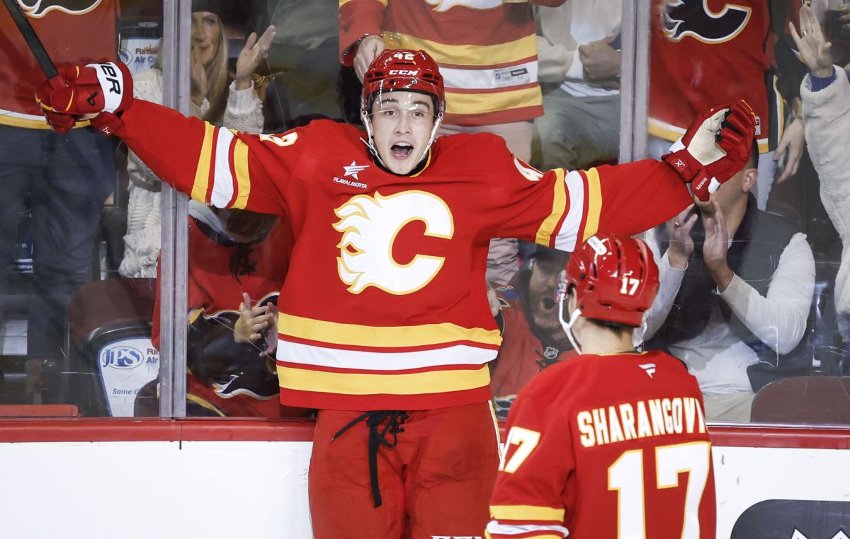 Calgary Flames' Sam Honzek, left, celebrates his goal with teammate Yegor Sharangovich during second period NHL pre-season hockey action against the Seattle Kraken in Calgary on Monday, Sept. 30, 2024.